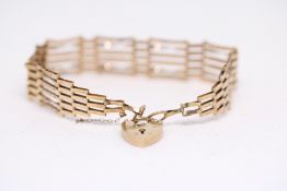 9ct Gold gate bracelet with heart shaped locket We