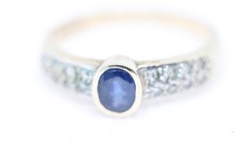 9ct Gold ring with central sapphire & chip diamond