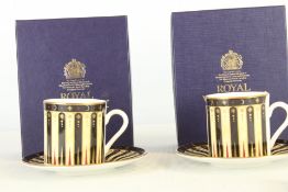 A pair of Royal Worcester Celebration 2001 coffee cans and saucers, boxed