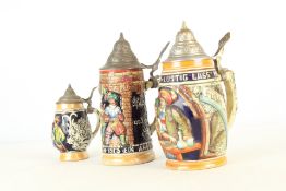 A group of ceramic beer steins with pewter lids