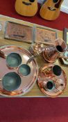 Group of copper kitchenware and framed copper ship plaques