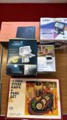 A group of boxed household electricals and a steak knife and fork set