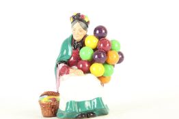 Glazed Ceramic Figurine of an Elderly Woman with Coloured Balls