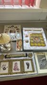 Group of baby keepsake photo frames and christening mementoes