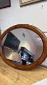 Oval stained-wood wall mirror