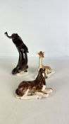 Three glazed ceramic animal models: elephant, giraffe and horse