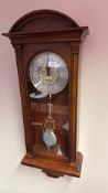 Mahogany-cased wall clock with arched pediment