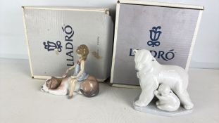 Two LladrÃ³ porcelain figures, including polar bear with cubs and girl seated on a dog