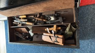 Woodworkerâ€™s tool chest containing assorted planes and hand tools