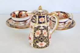 Royal Crown Derby Imari porcelain milk jug and a pair of teacups with saucers