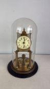 Brass four-glass mantel clock under glass dome