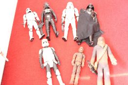 Group of Star Wars action figures including Darth Vader, stormtroopers, Imperial pilot and