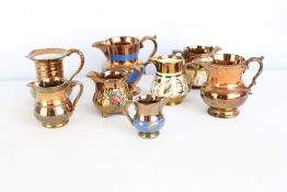 Group of lustre-glazed ceramic cream jugs and small pitchers