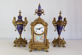 Gilt-metal and porcelain clock garniture, dial signed Imperial