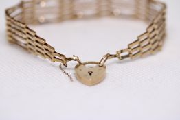 9ct Gold gate bracelet with heart shaped locket We