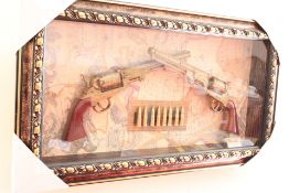 2 replica pistols in a shadow box