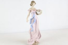 Lladró porcelain figure of a lady with flowers, hand made in Spain