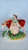 Staffordshire-pottery figure group of a milkmaid and cow A/F