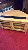 Modern light oak wood TV stand with black granite top and glazed cupboards