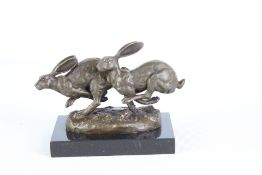 Bronze running hares on marble base