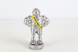 Small chrome Michelin man figure