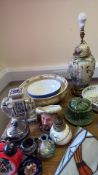 A mixed group of decorative ceramics and lighting, including a painted table lamp and stained-