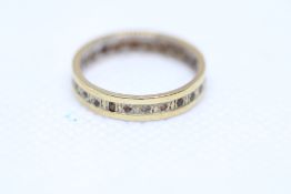 Yellow metal eternity ring Size L