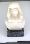 Alabaster bust of Virgin Mary on a marble base