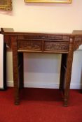 Chinese hardwood altar or console table, with raised scroll end supports above two foliate-carved