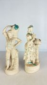 Pair of cream-glazed ceramic figural ornaments wit