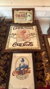 Three framed Coca-Cola advertising prints