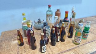 Six assorted miniature drinks bottles including Guinness, Harp Lager, Ricard and Drioli