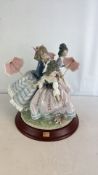 Lladro porcelain figural group three ladies with parasols and a small dog, modelled in pastel tones