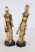 Pair of carved bone court-attendant figures on black bases