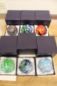 Group of six art glass paperweights in fitted cases