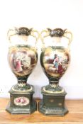 Pair of gilt and painted porcelain twin-handled urn vases (height 57cm)