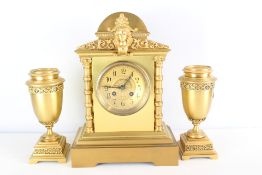 Late 19th century gilt-metal mantel clock garniture (clock and pair of urns)