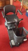 Modern mobility scooter with front basket in very good all-round condition, with boxed charger unit