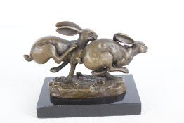 Bronze running hares on marble base