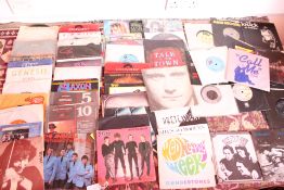 A Collection of Approximately 25 Vintage 7-Inch Vinyl Singles Featuring Blondie, Genesis, and The An