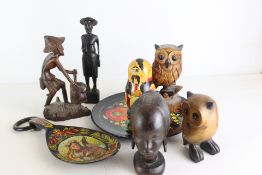 An Assortment of Wooden Folk Art Sculptures and Woven Baskets