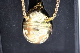 Ladies Secret Golden Gemmed Egg Pendant Watch on Gold Coloured Chain in Box with Booklet.