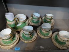 A 1930's Royal Worcester twelve setting part tea service having a white and green ground with ornate