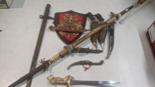 A collection of daggers to include a vintage military bayonet, an African tribal spear and other