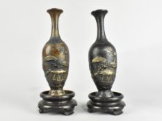 A Pair of Japanese Patinated Bronze Vases, The Bodies with Relief Decoration Depicting Fish and