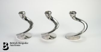 Three Contemporary Stainless Steel Candlesticks