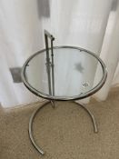 AFTER EILEEN GRAY DESIGNED E1027 ADJUSTABLE SIDE TABLE FEATURING A CHROME - PLATED TUBULAR STEEL
