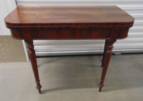 A mahogany rectangular games table with green baize on four turned tapering legs, 75.5 x 91.5 x