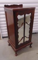 A late Victorian rectangular mahogany cabinet with mirrored door opening to reveal shelves, all on