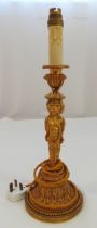 An ormolu table lamp, the stem with three cast caryatids on raised circular base with beaded border,